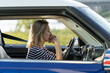 © DimaBerlin - Adult frustrated female sit inside car at driver seat putting chin on hands scared to start driving after vehicle accident or at first. Unhappy woman suffer headache, stress and anxiety in automobile