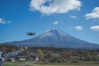 Hand catching drone aircraft in blue sky and Mt. Fuji background.