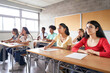 © CarlosBarquero - Group of students of different ethnicities sitting in class attending to the teacher. Young people studying at the college sitting at their desks.