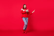 © deagreez - Photo of charming impressed young woman dressed print pullover pointing fingers empty space smiling isolated red color background
