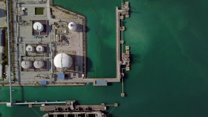 Wall Mural - Aerial view oil terminal storage tank, White oil tank storage chemical petroleum petrochemical refinery product at oil terminal, Business commercial trade fuel energy transport by tanker ship vessel.