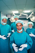 © NDABCREATIVITY - Portrait of a successful medical surgeon team inside operating room