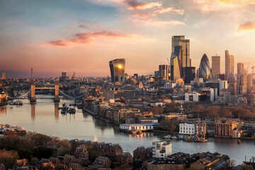 the skyline of london city with tower bridge and financial district skyscrapers during sunrise, engl