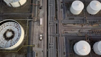 Wall Mural - Aerial view oil terminal storage tank, White oil tank storage chemical petroleum petrochemical refinery product at oil terminal, Business commercial trade fuel energy transport by tanker ship vessel.
