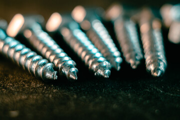 Wall Mural - Pile of screws on a black background