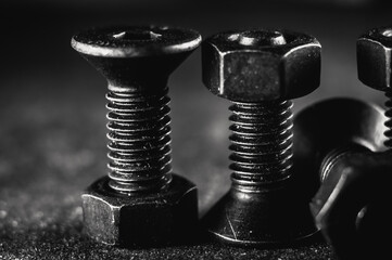 Poster - Grayscale shot of a pile of screws on a grunge background