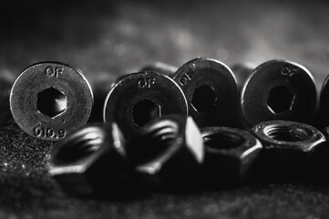 Sticker - Grayscale shot of a pile of bolts and nuts on a grunge background