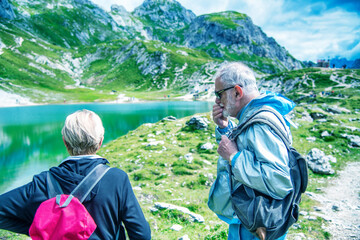 Sticker - Elderly retired couple relaxing in the middle of a mountain trip.