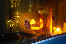 The Carved Pumpkin Looks Out The Window. Jack Lantern, Halloween Concept.