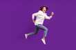 Full size profile side photo of young good mood girl running in air carefree rejoice isolated on purple color background
