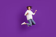 © deagreez - Full size photo of young excited cheerful girl jumping in triumph victory wear hoodie isolated on purple color background