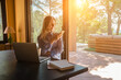 © Andrii IURLOV - Working from home. Woman talking on video call with Family, using smartphone and drinking tea. Online chat. Spend free time on terrace. Staying connected, Social distancing, internet, chatting. Work.