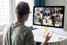 View From Back Above Male Shoulder On The Laptop With Diverse Employees, Coworkers On The Screen, Video Call, Online Meeting. App For Video Conference With Many People Together