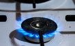 © Alpar - Burning  kitchen gas stove with blue flames  close up shot .