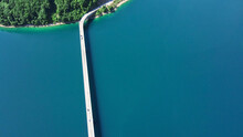 Aerial Footage A Car Driving Over A Bridge On Piva Lake