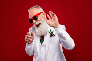 Wall Mural - Photo of happy funky positive old man wear sunglass dance christmas showman isolated on red color background