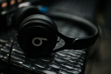 Selective Focus Shot Of Black Beats Headphones On A Metallic Surface