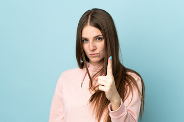 Sticker - Young caucasian woman isolated on blue background frustrated and pointing to the front