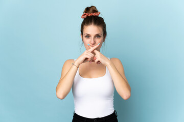 Sticker - Young caucasian woman isolated on blue background showing a sign of silence gesture