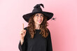 © luismolinero - Young caucasian woman celebrating halloween isolated on pink background pointing up and surprised