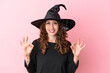 © luismolinero - Young caucasian woman celebrating halloween isolated on pink background showing an ok sign with fingers