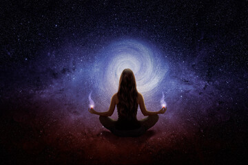 Woman with yoga pose in front of the blue universe