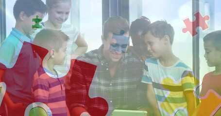 Sticker - Animation of colourful puzzle pieces over school children with male teacher