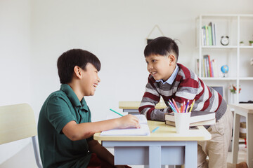 Two happy students talking and having fun inside a class