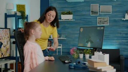 Wall Mural - Child playing video games while mother interrupting play for homework and school tasks. Parent stopping action game on computer for little girl to learn for online courses and lessons