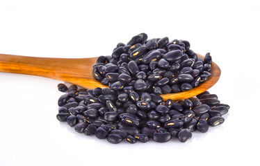 Wall Mural - black beans in wood spoon on white background