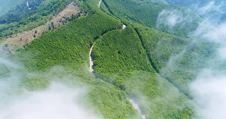 Wall Mural - flying above mountain hills and peaks during foggy morning sunrise. mountains landscape aerial drone