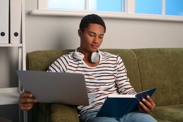 Wall Mural - African-American student preparing for exam at home