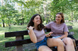 © hannamartysheva - Mom and teenage daughter use a smartphone for a walk in a summer park