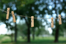 Clothespins Hanging On Laundry Line Outdoors