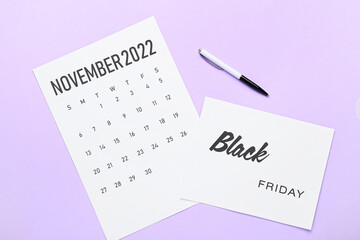 Poster - Calendar page of November 2022 and pen on color background. Black Friday