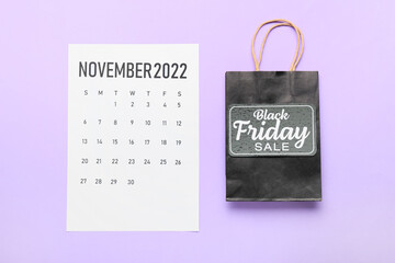 Poster - Calendar page of November 2022 and shopping bag on color background. Black Friday