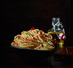 Wall Mural - Appetizing pasta in bowl on dark table