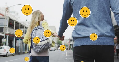 Poster - Animation of digital emoji icons floating over happy caucasian couple walking and holding hands