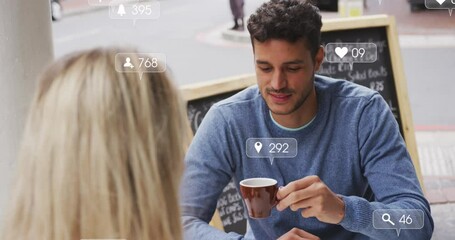 Poster - Animation of social media icons floating over caucasian couple talking and drinking coffee