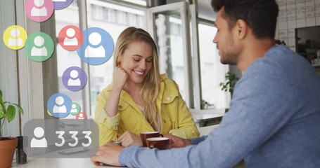 Poster - Animation of social media icons floating over happy caucasian couple talking and drinking coffee