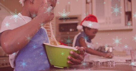 Wall Mural - Animation of snow falling over two smiling children with santa hats preparing cookies