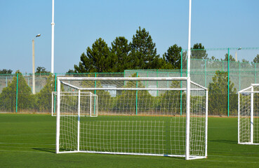 Wall Mural - an empty football goal with a stretched net in a green stadium, the arena is prepared for the futsal championship. healthy lifestyle and sports concept