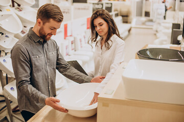 Man choosing a batgh sink with sales person