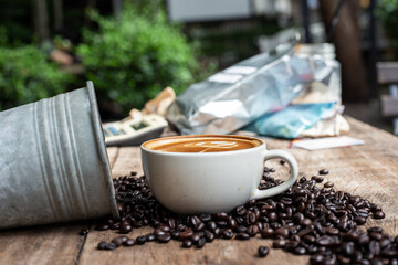 Wall Mural - Hot latte art coffee with coffee bean on wooden table