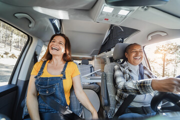 Wall Mural - Multiracial senior women having fun on the road in camper van - Focus on left woman face