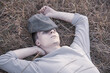 © FO_DE - Portrait of a young man of 18 years old, lying in the dry grass.