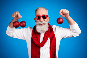 Sticker - Photo of funny sweet mature man dressed white pullover arms glasses holding new year balls smiling isolated blue color background