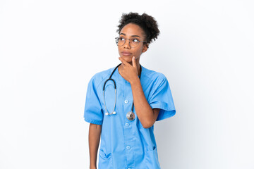 Sticker - Young surgeon African American doctor woman isolated on white background having doubts and with confuse face expression