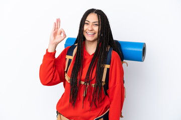 Wall Mural - Hiker teenager girl with braids over isolated white background showing ok sign with fingers