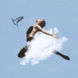 Contemporary art collage of male ballet dancer in motion covered with cloud. Dove flying isolated over blue background